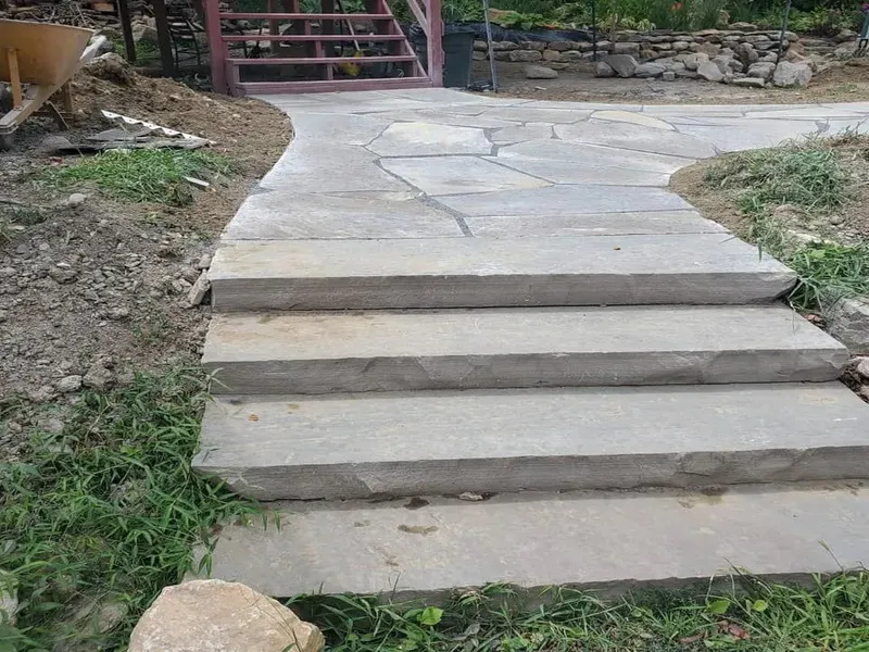 Natural stone retaining wall built by Lawn Spa Landscaping