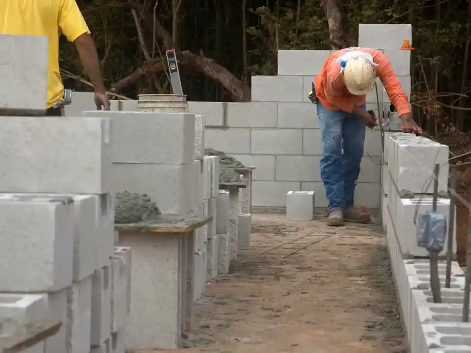Construction workers building a wall
